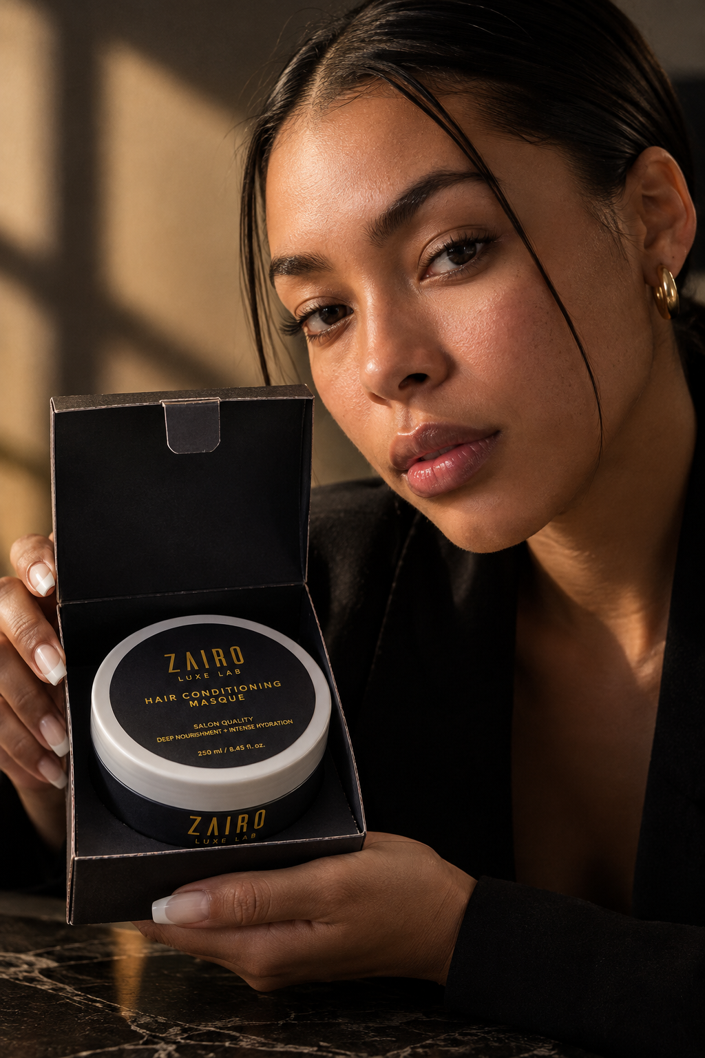 Model presenting the open Zairo gift box in warm golden light